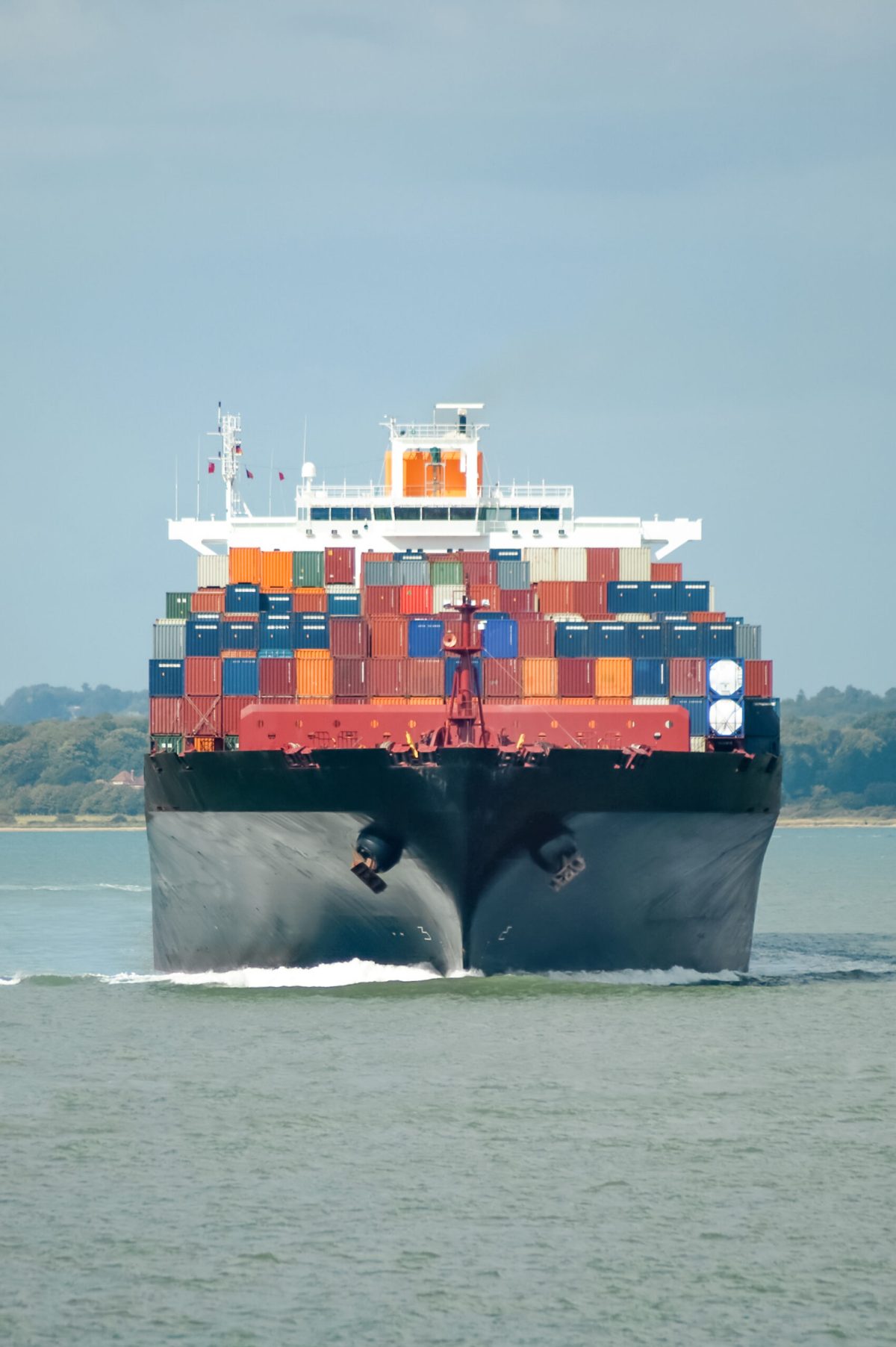 fully loaded container ship head-on in calm water